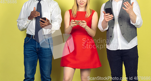 Image of Group of friends using mobile smartphones. Teenagers addiction to new technology trends. Close up.