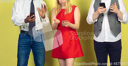 Image of Group of friends using mobile smartphones. Teenagers addiction to new technology trends. Close up.