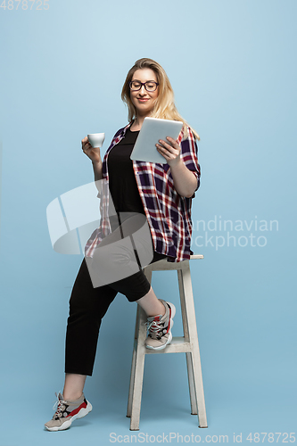 Image of Young caucasian woman in casual wear on blue background. Bodypositive female character, plus size businesswoman