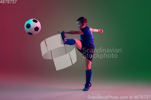 Image of Teen male football or soccer player, boy on gradient background in neon light - motion, action, activity concept