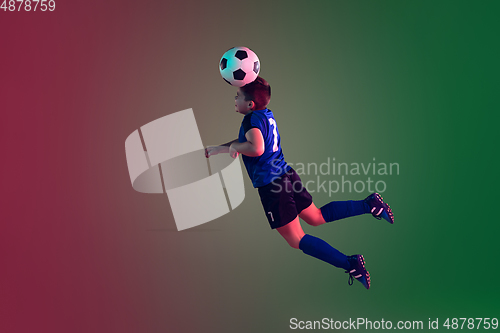 Image of Teen male football or soccer player, boy on gradient background in neon light - motion, action, activity concept