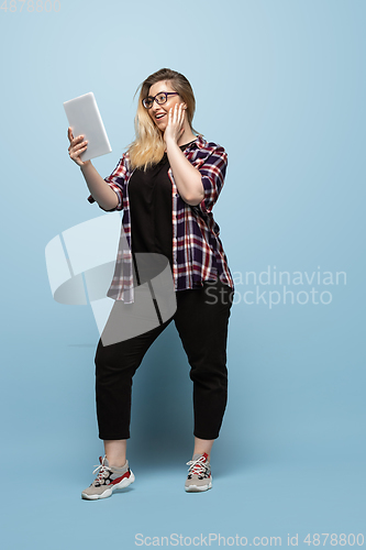 Image of Young caucasian woman in casual wear on blue background. Bodypositive female character, plus size businesswoman