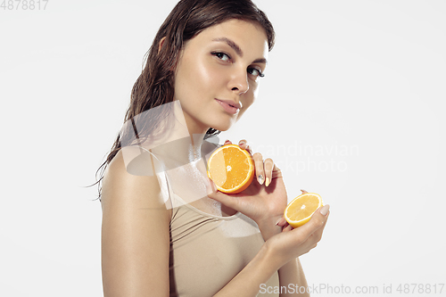 Image of Close up of beautiful young woman over white background. Cosmetics and makeup, natural and eco treatment, skin care.