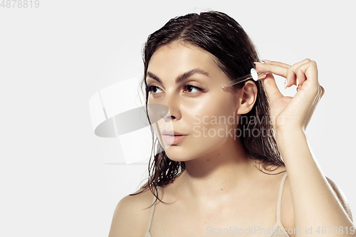 Image of Close up of beautiful young woman over white background. Cosmetics and makeup, natural and eco treatment, skin care.