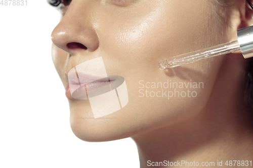 Image of Close up of beautiful young woman over white background. Cosmetics and makeup, natural and eco treatment, skin care.