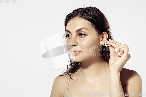 Image of Close up of beautiful young woman over white background. Cosmetics and makeup, natural and eco treatment, skin care.