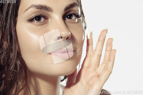 Image of Close up of beautiful young woman over white background. Cosmetics and makeup, natural and eco treatment, skin care.