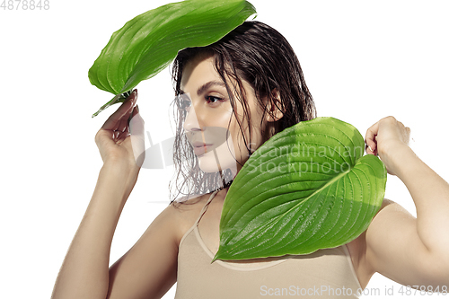 Image of Close up of beautiful young woman over white background. Cosmetics and makeup, natural and eco treatment, skin care.