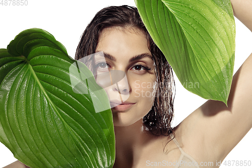 Image of Close up of beautiful young woman over white background. Cosmetics and makeup, natural and eco treatment, skin care.