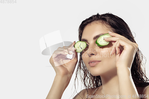 Image of Close up of beautiful young woman over white background. Cosmetics and makeup, natural and eco treatment, skin care.