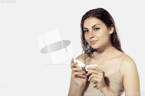 Image of Close up of beautiful young woman over white background. Cosmetics and makeup, natural and eco treatment, skin care.