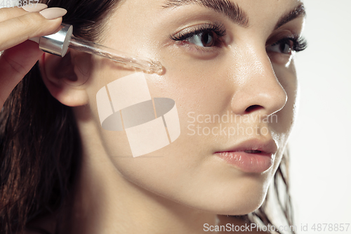Image of Close up of beautiful young woman over white background. Cosmetics and makeup, natural and eco treatment, skin care.