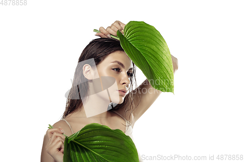 Image of Close up of beautiful young woman over white background. Cosmetics and makeup, natural and eco treatment, skin care.