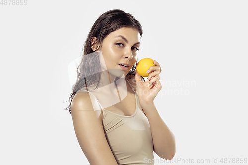 Image of Close up of beautiful young woman over white background. Cosmetics and makeup, natural and eco treatment, skin care.