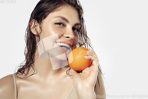 Image of Close up of beautiful young woman over white background. Cosmetics and makeup, natural and eco treatment, skin care.