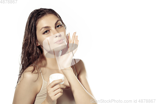 Image of Close up of beautiful young woman over white background. Cosmetics and makeup, natural and eco treatment, skin care.