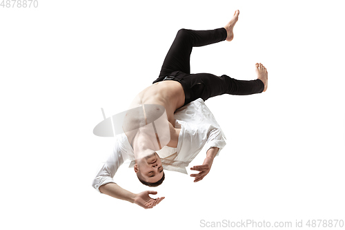 Image of Mid-air beauty. Full length studio shot of attractive young man hovering in air and keeping eyes closed