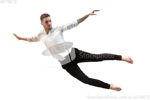 Image of Mid-air beauty. Full length studio shot of attractive young man hovering in air and keeping eyes closed