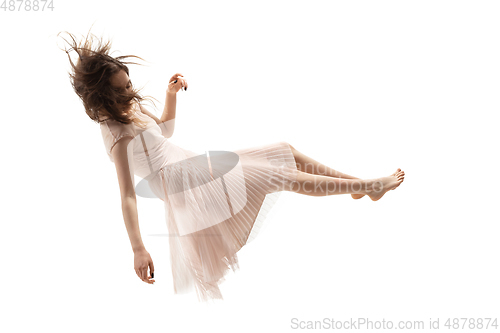 Image of Mid-air beauty. Full length studio shot of attractive young woman hovering in air and keeping eyes closed