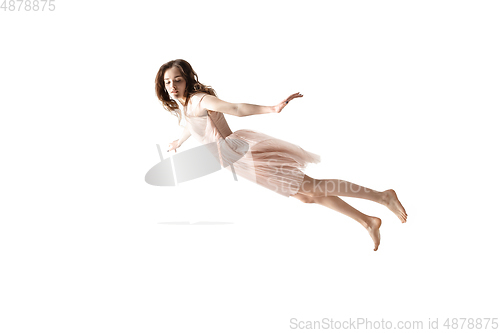 Image of Mid-air beauty. Full length studio shot of attractive young woman hovering in air and keeping eyes closed