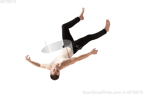 Image of Mid-air beauty. Full length studio shot of attractive young man hovering in air and keeping eyes closed