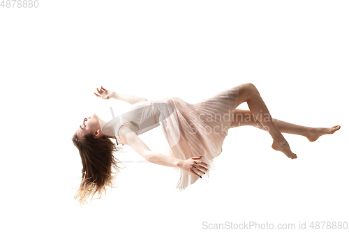 Image of Mid-air beauty. Full length studio shot of attractive young woman hovering in air and keeping eyes closed