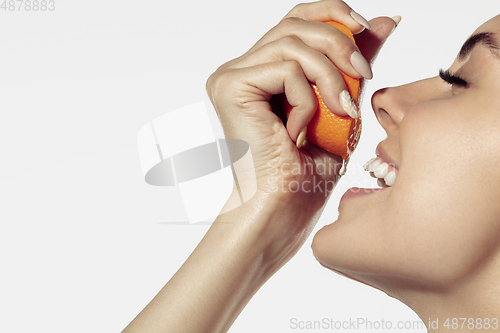 Image of Close up of beautiful young woman over white background. Cosmetics and makeup, natural and eco treatment, skin care.