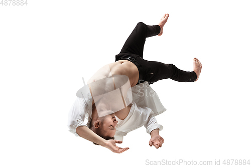 Image of Mid-air beauty. Full length studio shot of attractive young man hovering in air and keeping eyes closed