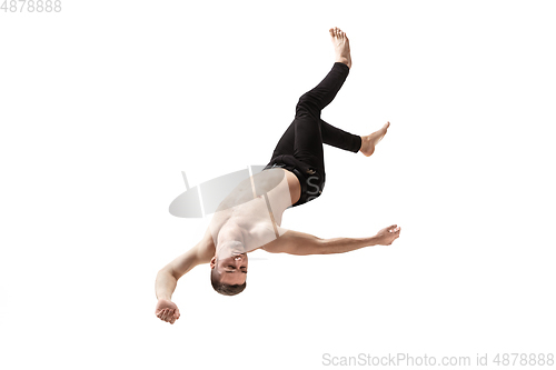 Image of Mid-air beauty. Full length studio shot of attractive young man hovering in air and keeping eyes closed