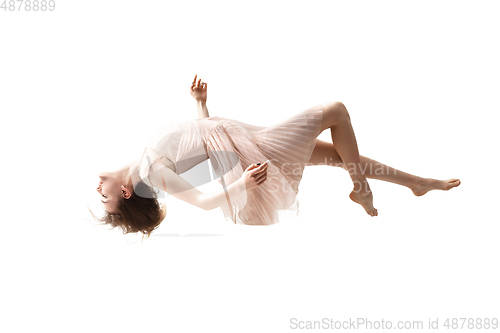 Image of Mid-air beauty. Full length studio shot of attractive young woman hovering in air and keeping eyes closed