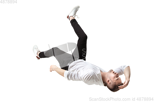 Image of Mid-air beauty. Full length studio shot of attractive young man hovering in air and keeping eyes closed