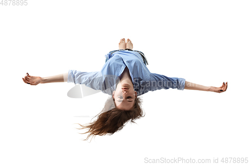 Image of Mid-air beauty. Full length studio shot of attractive young woman hovering in air and keeping eyes closed