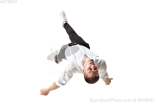 Image of Mid-air beauty. Full length studio shot of attractive young man hovering in air and keeping eyes closed