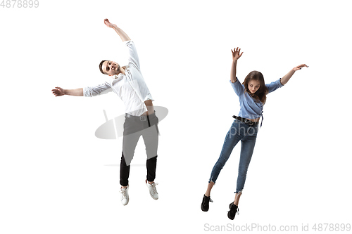 Image of Mid-air beauty. Full length studio shot of attractive young woman and man hovering in air and keeping eyes closed