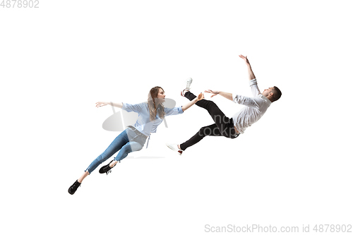 Image of Mid-air beauty. Full length studio shot of attractive young woman and man hovering in air and keeping eyes closed