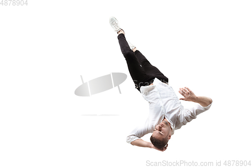 Image of Mid-air beauty. Full length studio shot of attractive young man hovering in air and keeping eyes closed