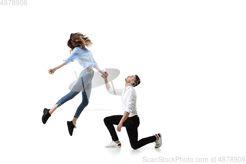 Image of Mid-air beauty. Full length studio shot of attractive young woman and man hovering in air and keeping eyes closed