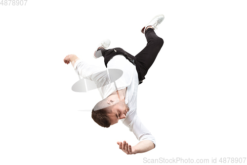 Image of Mid-air beauty. Full length studio shot of attractive young man hovering in air and keeping eyes closed