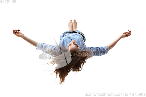 Image of Mid-air beauty. Full length studio shot of attractive young woman hovering in air and keeping eyes closed