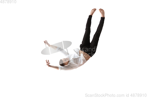 Image of Mid-air beauty. Full length studio shot of attractive young man hovering in air and keeping eyes closed