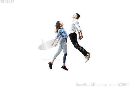 Image of Mid-air beauty. Full length studio shot of attractive young woman and man hovering in air and keeping eyes closed