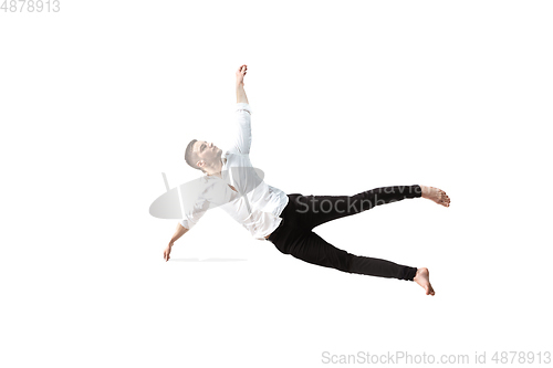Image of Mid-air beauty. Full length studio shot of attractive young man hovering in air and keeping eyes closed