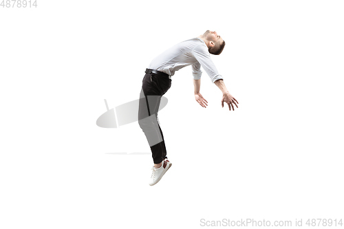 Image of Mid-air beauty. Full length studio shot of attractive young man hovering in air and keeping eyes closed