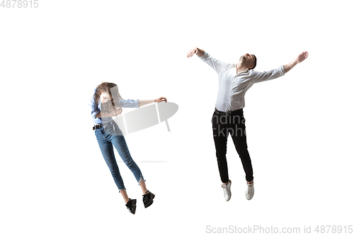 Image of Mid-air beauty. Full length studio shot of attractive young woman and man hovering in air and keeping eyes closed