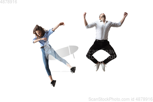 Image of Mid-air beauty. Full length studio shot of attractive young woman and man hovering in air and keeping eyes closed
