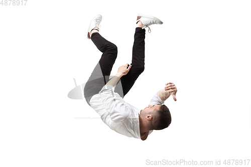 Image of Mid-air beauty. Full length studio shot of attractive young man hovering in air and keeping eyes closed