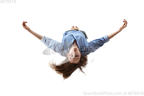 Image of Mid-air beauty. Full length studio shot of attractive young woman hovering in air and keeping eyes closed