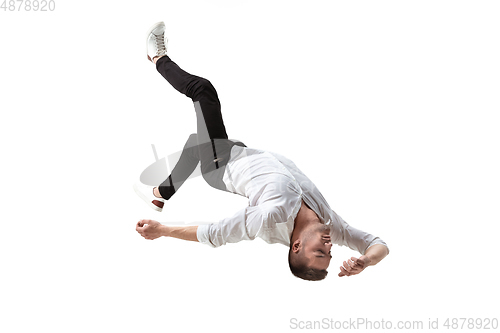 Image of Mid-air beauty. Full length studio shot of attractive young man hovering in air and keeping eyes closed