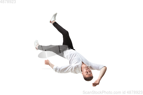 Image of Mid-air beauty. Full length studio shot of attractive young man hovering in air and keeping eyes closed