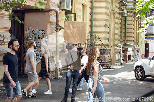 Image of Dude with sign - man stands protesting things that annoy him